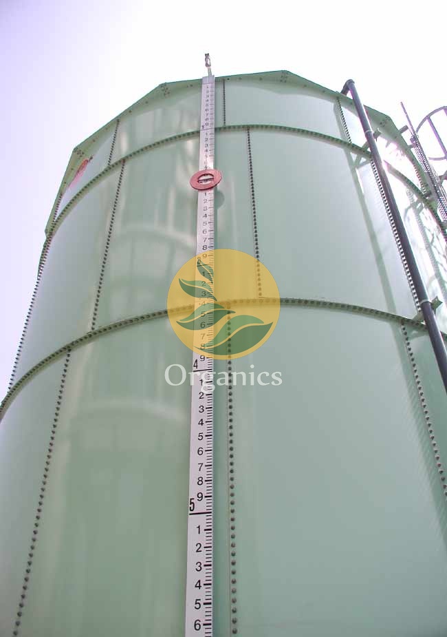 Close-up of a biogas storage vessel with measurement markings on an anaerobic digestion facility