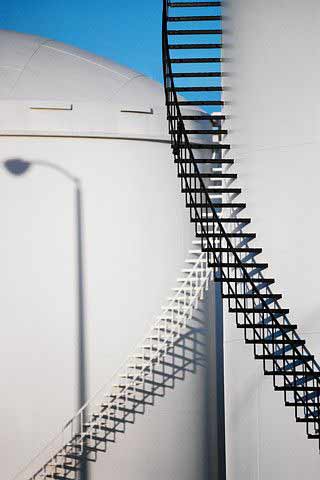 Cryogenic storage tanks with external staircase at a methane liquefaction facility