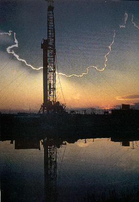 Drilling rig at sunset extracting coal bed methane from an underground seam