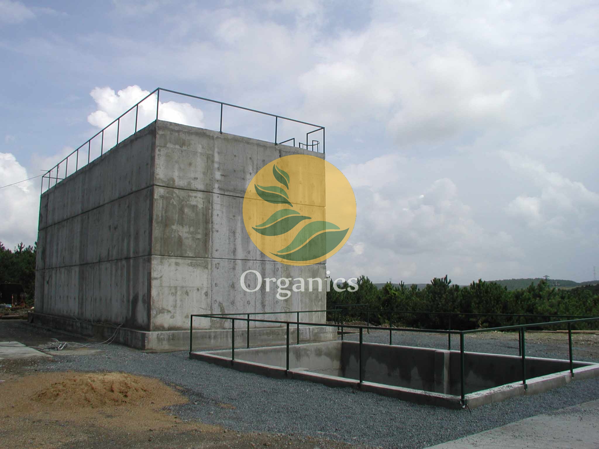 Exterior view of a concrete anaerobic digestion tank at an industrial site