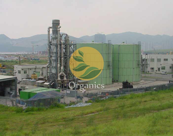 Exterior view of large green SBR tanks at a landfill leachate treatment facility