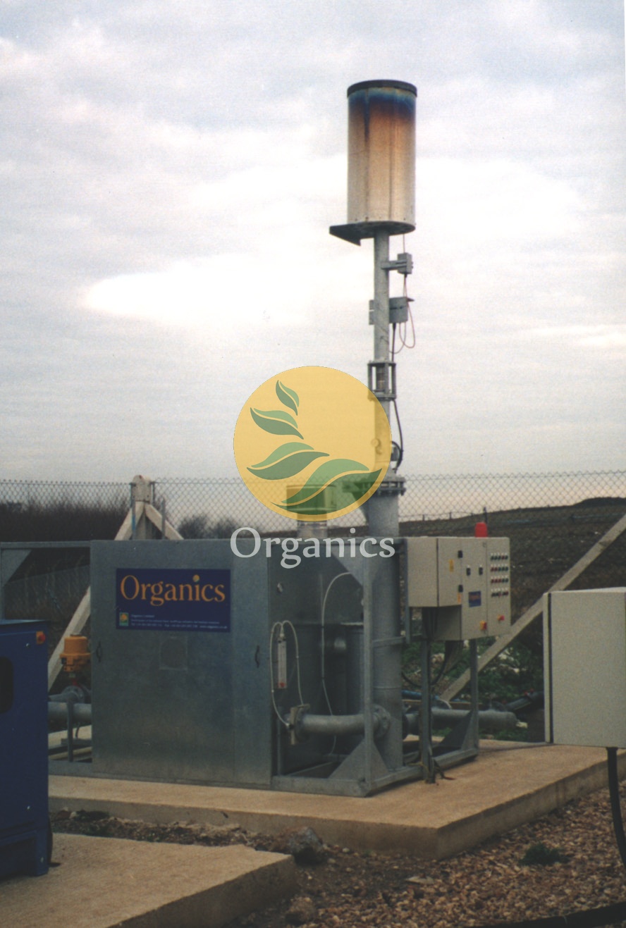 Landfill gas flare stack installed on an active landfill site with visible flame plume