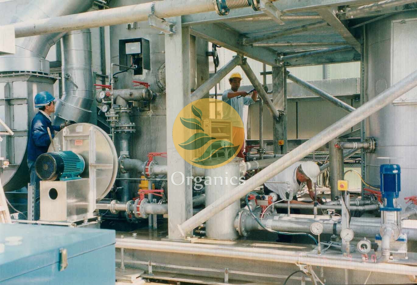 Site technicians inspecting pumps and control panel of a humidifier evaporator system