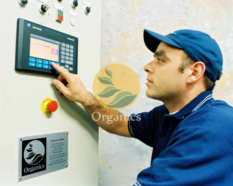 Technician adjusting a gas analyser touchscreen interface at a landfill site