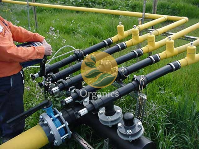 Technician conducting a landfill gas pumping trial at a wellhead